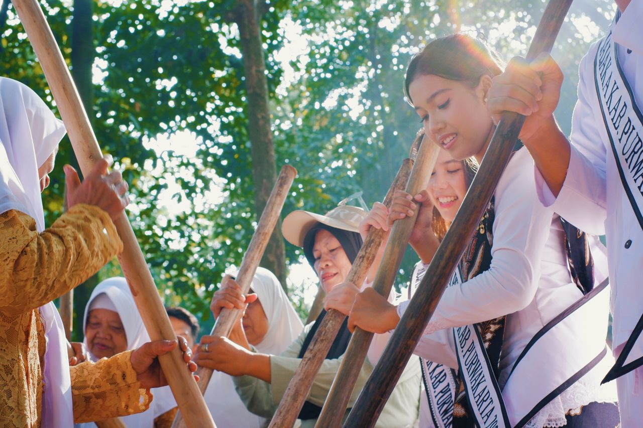 People engaged in a traditional event in West Java, Indonesia, showcasing cultural diversity and unity.